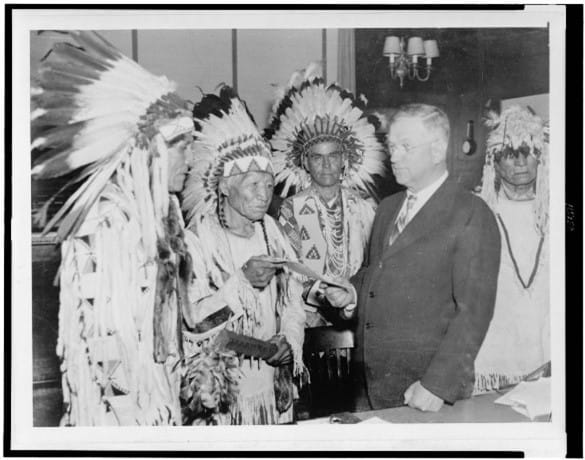 Unattributed. Secretary of Interior Harold Ickes handing first constitution issued under the Indian Reorganization Act to delegates of the Confederated Tribes of the Flathead Indian Reservation. October 28, 1935. Library of Congress, Prints & Photographs Division.