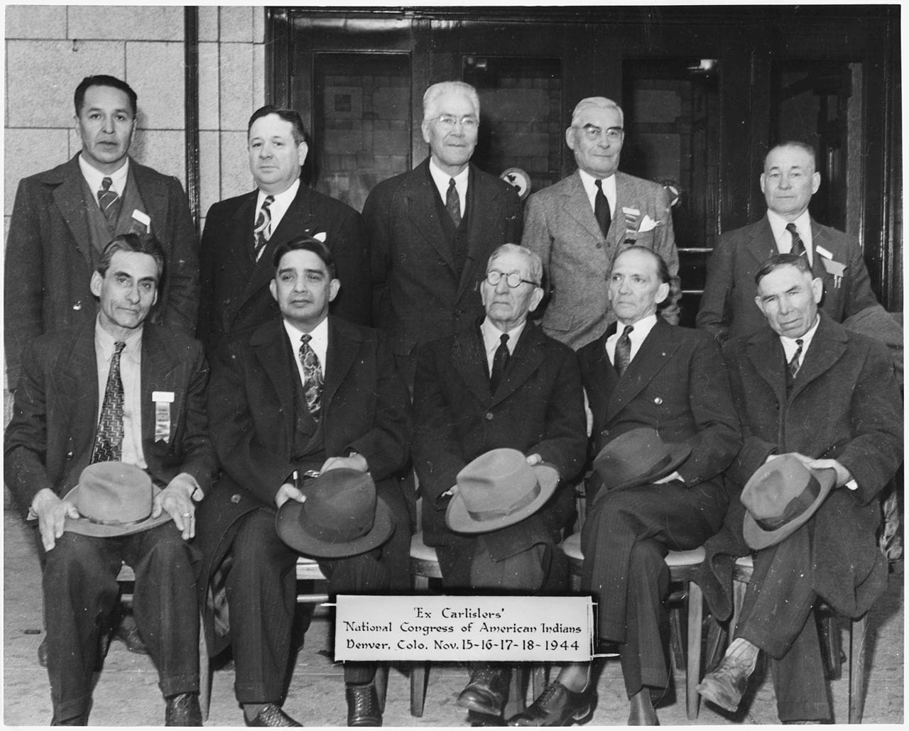 "Representatives of Various Tribes Attending Organizational Meeting of the National Congress of American Indians Including Football Player Albert Exendine." National Archives and Records Administration, Department of the Interior. Bureau of Indian Affairs. Portland Area Office. Tribal Operations Branch, 1947-1967. Wikimedia Commons, https://commons.wikimedia.org/wiki/File:Representatives_of_various_tribes_attending_organizational_meeting_of_the_National_Congress_of_American_Indians..._-_NARA_-_298658.jpg.